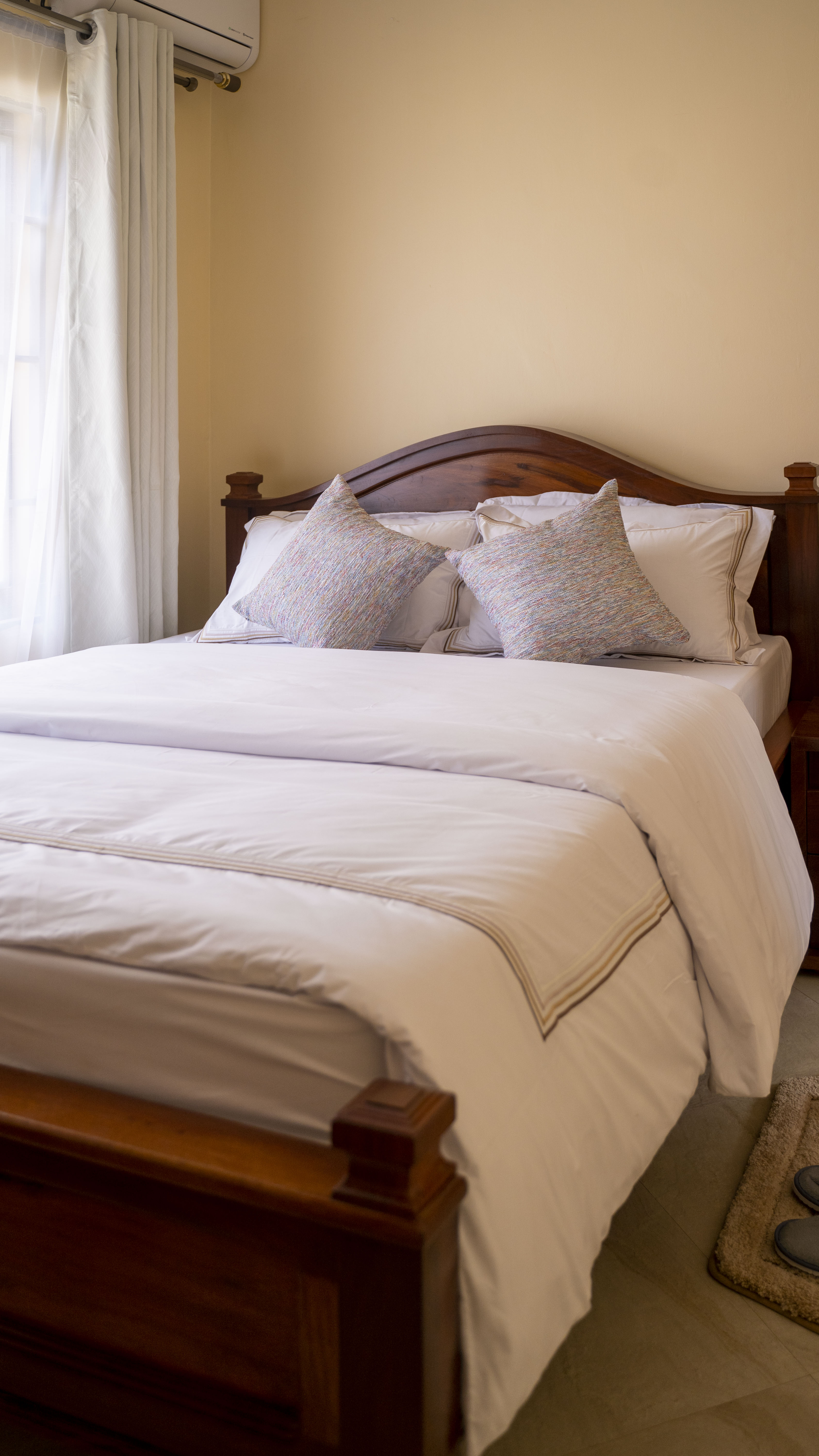 Guest bedroom — mninga bed frame and freshly pressed white Egyptian-cotton linens